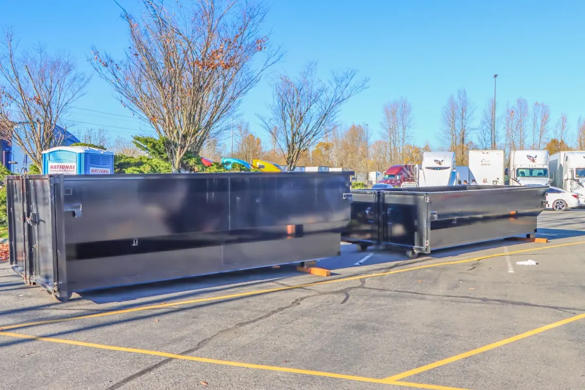 Professional dumpster rental service with roll-off container on residential driveway in Aventura